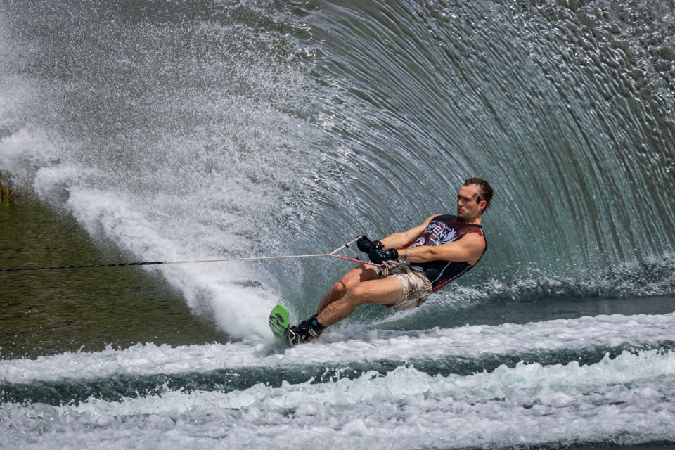 Slalom skier carving through a curtain of spray