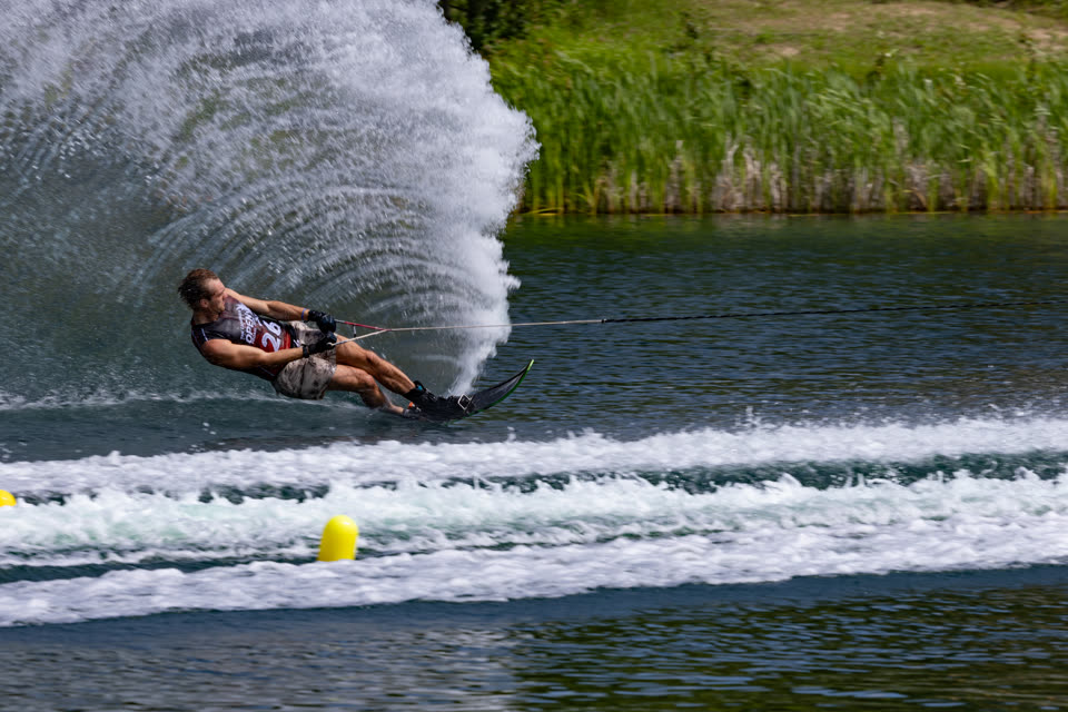 Spray dome over a skier rounding the buoy